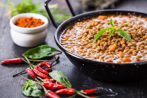 Authentic Indian dish surrounded by mini hot peppers